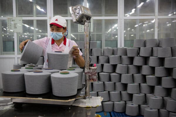 A worker packaging spools of cotton yarn at factory visited by foreign journalists on a government-organized tour in Xinjiang last year. Concerns about Uyghur forced labor largely revolve around the clothing industry.