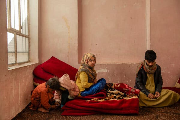 Jamila Jamshidi, 25, and her brother, Omid, 18, sit in their cold apartment. They both sold kidneys to help support their family.