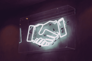 Neon sign of handshake icon